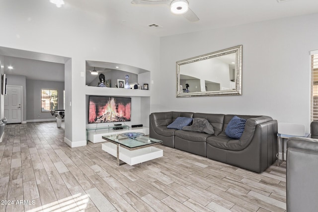 living room with light wood-type flooring and ceiling fan