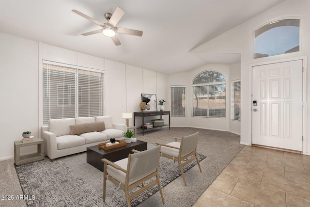 tiled living room featuring ceiling fan and vaulted ceiling