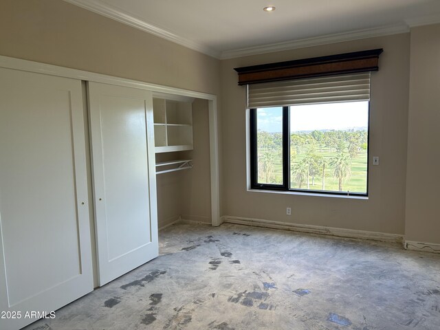 unfurnished bedroom featuring crown molding, baseboards, and a closet