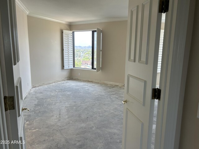 empty room with crown molding and concrete floors