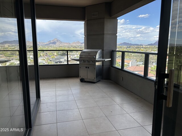 balcony with a mountain view and area for grilling