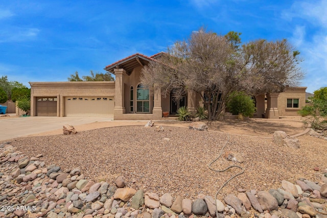 4922 W Fallen Leaf Ln, Glendale, AZ 85310 - view of front of property featuring driveway, a garage, stucco siding, and a tile roof