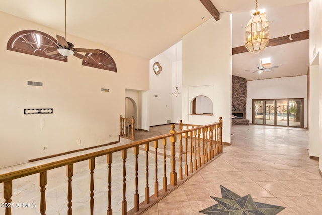 4922 W Fallen Leaf Ln, Glendale, AZ 85310 - hallway with high vaulted ceiling, beamed ceiling, tile patterned floors, and a chandelier