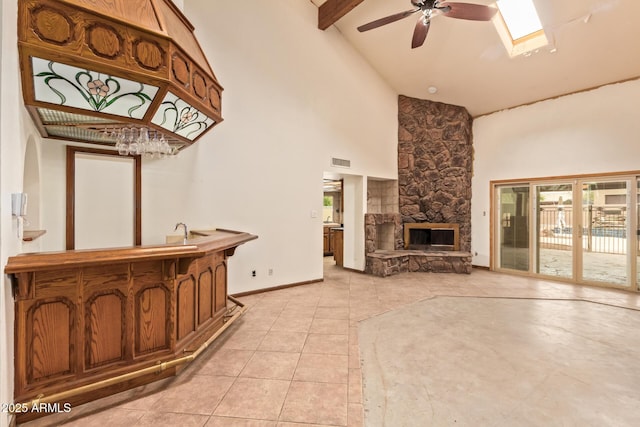 4922 W Fallen Leaf Ln, Glendale, AZ 85310 - living room featuring high vaulted ceiling, a ceiling fan, bar with sink, a fireplace, and light tile patterned floors