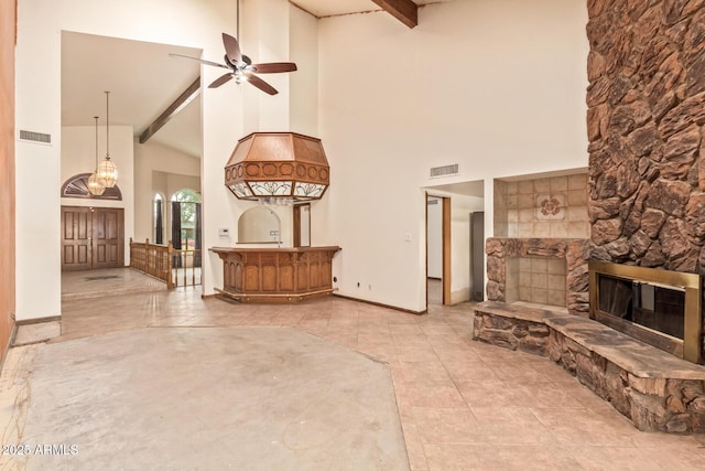 4922 W Fallen Leaf Ln, Glendale, AZ 85310 - unfurnished living room with high vaulted ceiling, beamed ceiling, a fireplace, ceiling fan, and baseboards