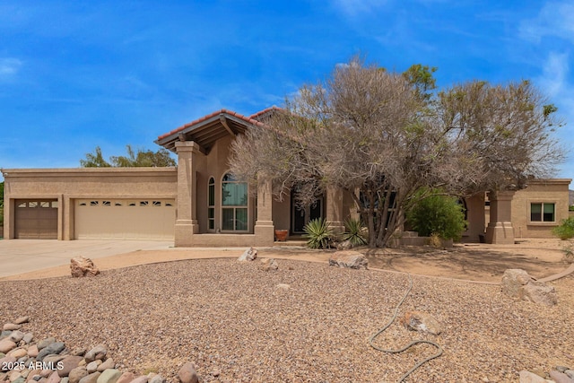 4922 W Fallen Leaf Ln, Glendale, AZ 85310 - view of front of property featuring stucco siding, concrete driveway, an attached garage, and a tiled roof