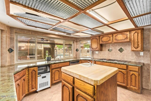 4922 W Fallen Leaf Ln, Glendale, AZ 85310 - kitchen with a sink, appliances with stainless steel finishes, wood counters, and a center island with sink