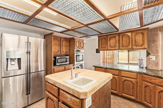4922 W Fallen Leaf Ln, Glendale, AZ 85310 - kitchen with appliances with stainless steel finishes, a sink, and brown cabinets
