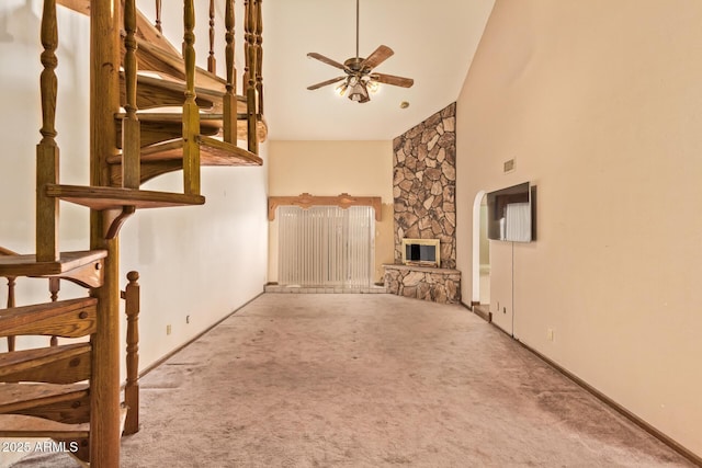 4922 W Fallen Leaf Ln, Glendale, AZ 85310 - unfurnished living room featuring carpet floors, high vaulted ceiling, ceiling fan, a fireplace, and baseboards
