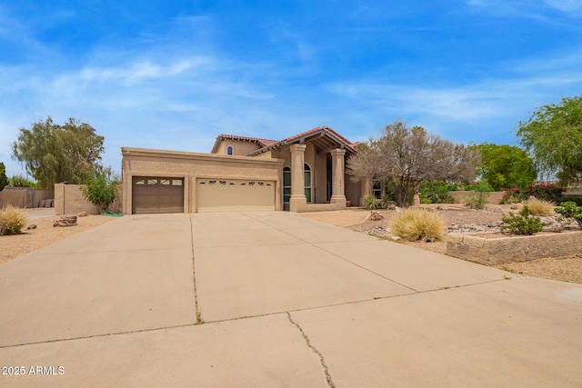 4922 W Fallen Leaf Ln, Glendale, AZ 85310 - mediterranean / spanish home with an attached garage, stucco siding, concrete driveway, and a tiled roof