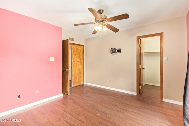 4922 W Fallen Leaf Ln, Glendale, AZ 85310 - empty room featuring a ceiling fan, wood finished floors, and baseboards