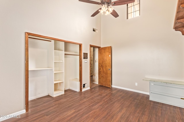 4922 W Fallen Leaf Ln, Glendale, AZ 85310 - unfurnished bedroom featuring dark wood-style flooring, baseboards, a closet, a high ceiling, and a ceiling fan