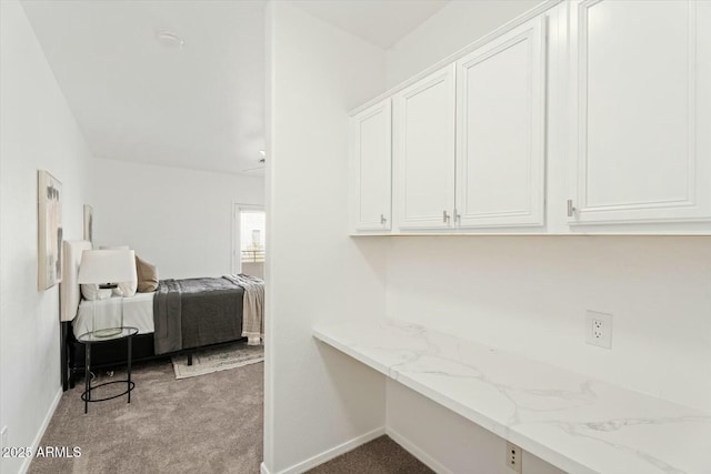 washroom featuring light carpet and baseboards