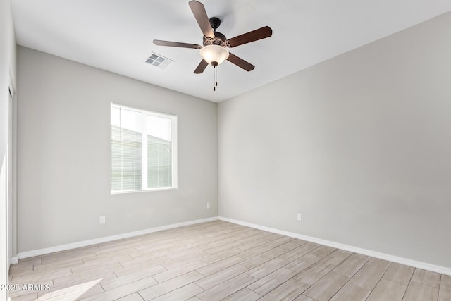 spare room featuring light wood-type flooring and ceiling fan