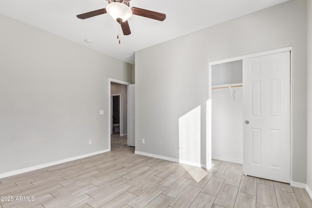 unfurnished bedroom with ceiling fan and a closet