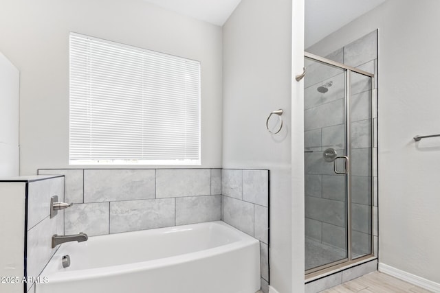 bathroom with shower with separate bathtub