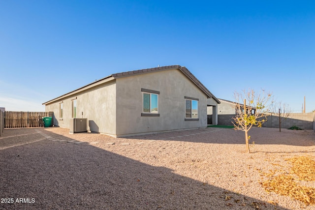 rear view of house featuring central air condition unit