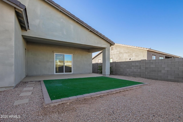 rear view of property with a patio and a yard