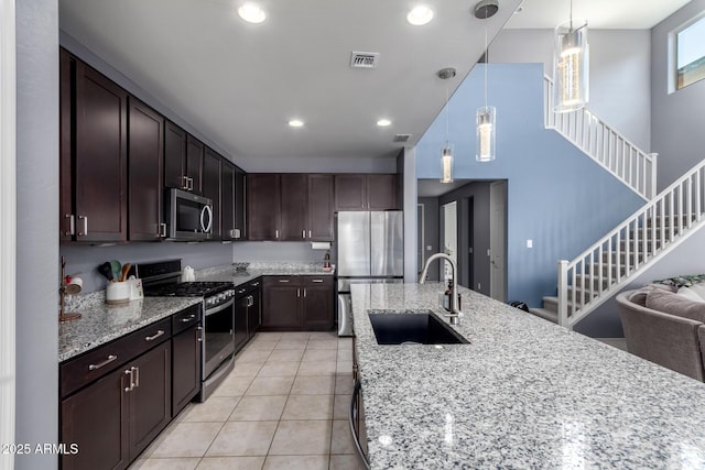 25627 N 163rd Dr, Surprise, AZ 85387 - kitchen featuring a sink, visible vents, light stone countertops, and stainless steel appliances