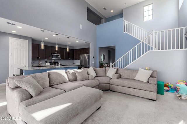 25627 N 163rd Dr, Surprise, AZ 85387 - living room with light carpet, stairs, visible vents, and recessed lighting