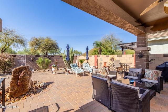 view of patio with grilling area, a fenced backyard, and an outdoor living space