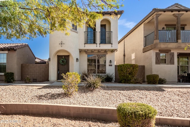 view of front of home featuring a balcony and stucco siding