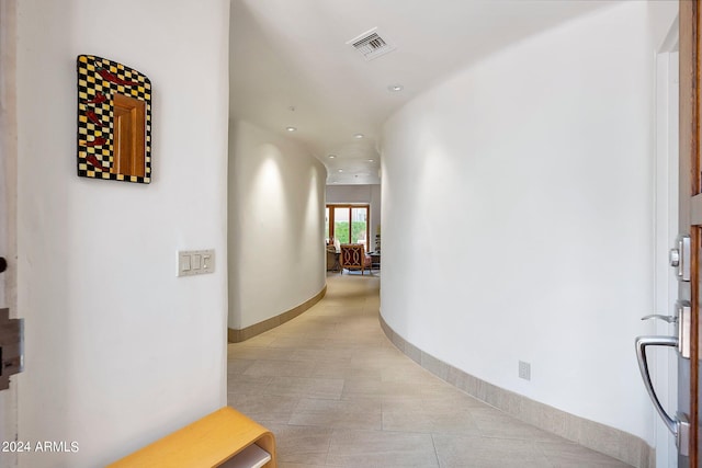 corridor featuring light tile patterned floors