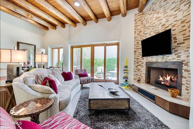 tiled living room with a fireplace, beam ceiling, wooden ceiling, and a high ceiling