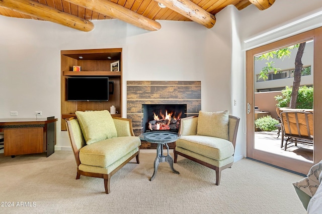 living area with beamed ceiling, light colored carpet, a wealth of natural light, and wooden ceiling