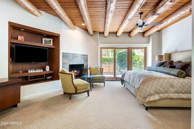 carpeted bedroom with access to outside, a tile fireplace, wood ceiling, and beam ceiling