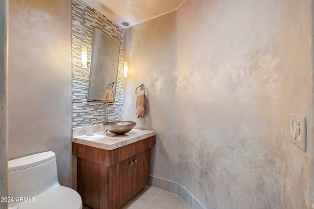 bathroom featuring tile patterned flooring, vanity, and toilet