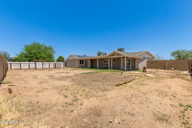 1676 W Sequoia Dr, Phoenix, AZ 85027 - back of property with roof mounted solar panels, a fenced backyard, and a chimney