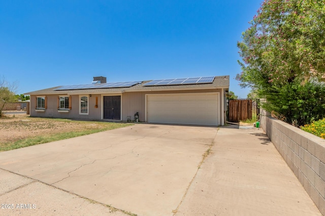 1676 W Sequoia Dr, Phoenix, AZ 85027 - view of front of house with a garage, roof mounted solar panels, and driveway
