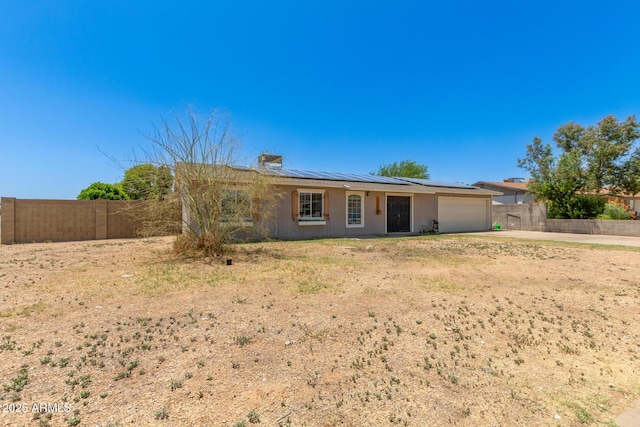 1676 W Sequoia Dr, Phoenix, AZ 85027 - single story home with a garage, solar panels, concrete driveway, a chimney, and a metal roof