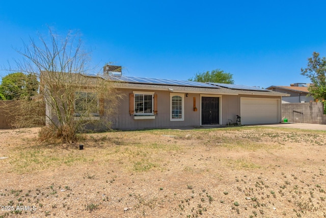 1676 W Sequoia Dr, Phoenix, AZ 85027 - ranch-style house with a garage, solar panels, concrete driveway, a metal roof, and a chimney