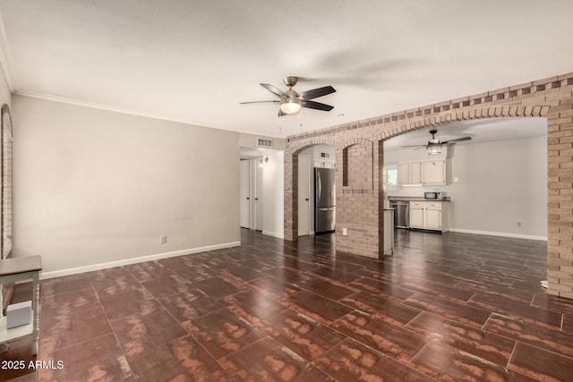 1676 W Sequoia Dr, Phoenix, AZ 85027 - unfurnished living room with ceiling fan, dark wood-style floors, brick wall, arched walkways, and crown molding