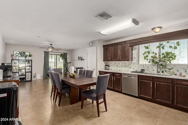 dining area featuring a textured ceiling, ceiling fan, light tile patterned floors, and sink