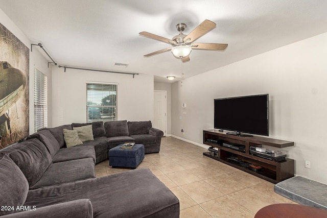 tiled living room with ceiling fan