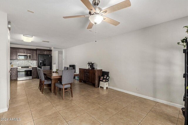 tiled dining space featuring ceiling fan