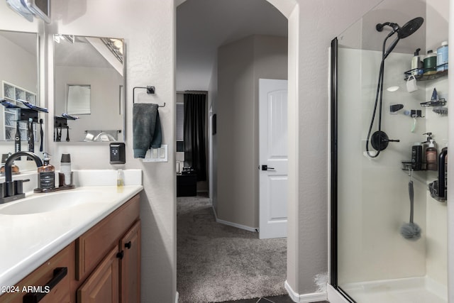 bathroom featuring walk in shower and vanity