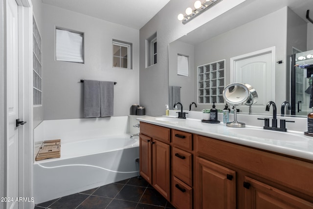 bathroom featuring a bath, vanity, and tile patterned floors