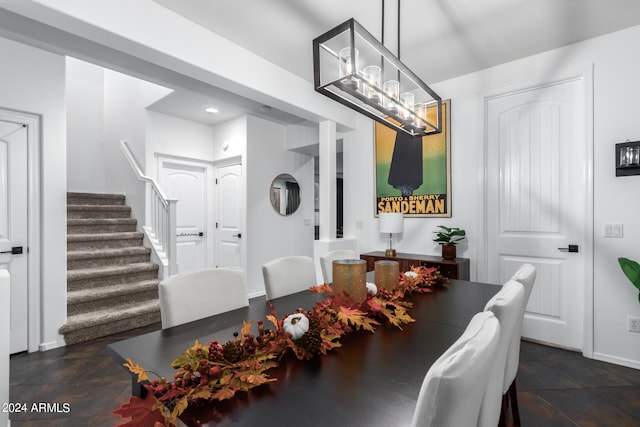 tiled dining space featuring a notable chandelier