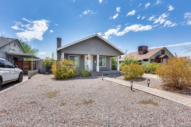 bungalow-style home featuring a carport and a porch