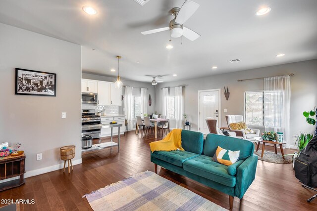 living room featuring a wealth of natural light and dark hardwood / wood-style flooring