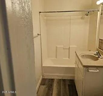 bathroom with vanity, shower / bath combination, and hardwood / wood-style floors