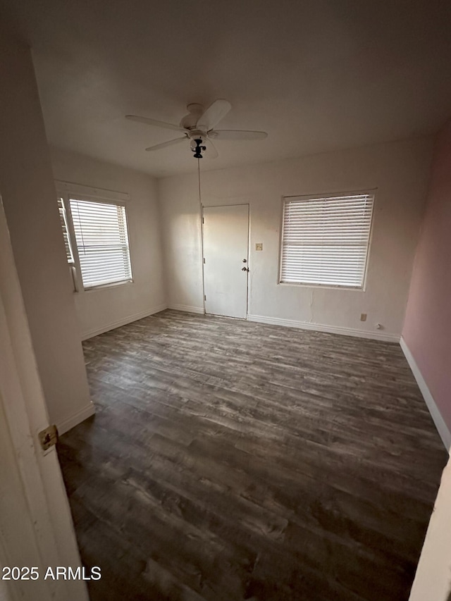 unfurnished room with dark wood-type flooring and ceiling fan