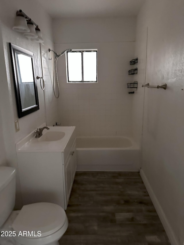 full bathroom with vanity, tiled shower / bath, wood-type flooring, and toilet