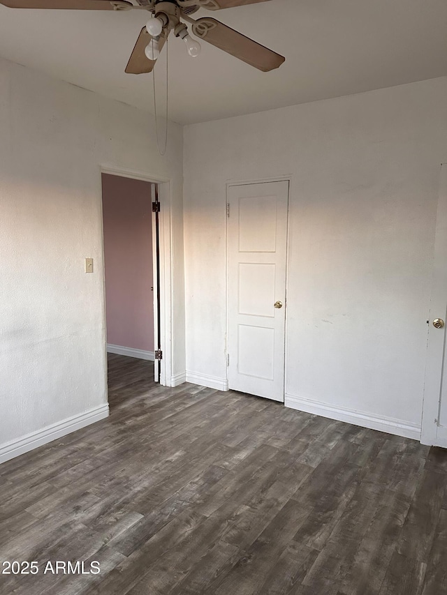 spare room featuring dark hardwood / wood-style flooring and ceiling fan