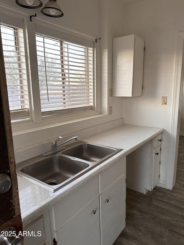 kitchen featuring white cabinetry, sink, and dark wood-type flooring