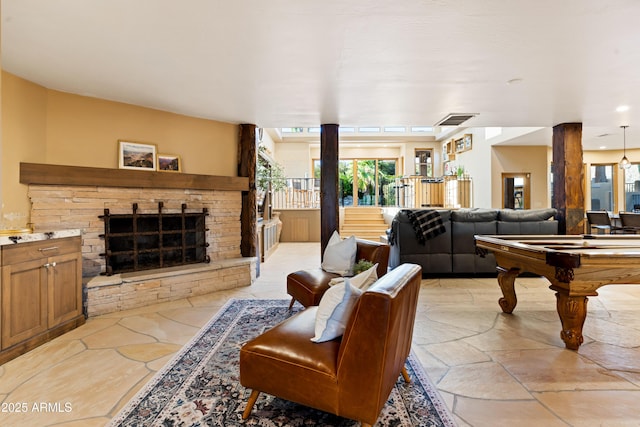 living room with a fireplace, billiards, and visible vents